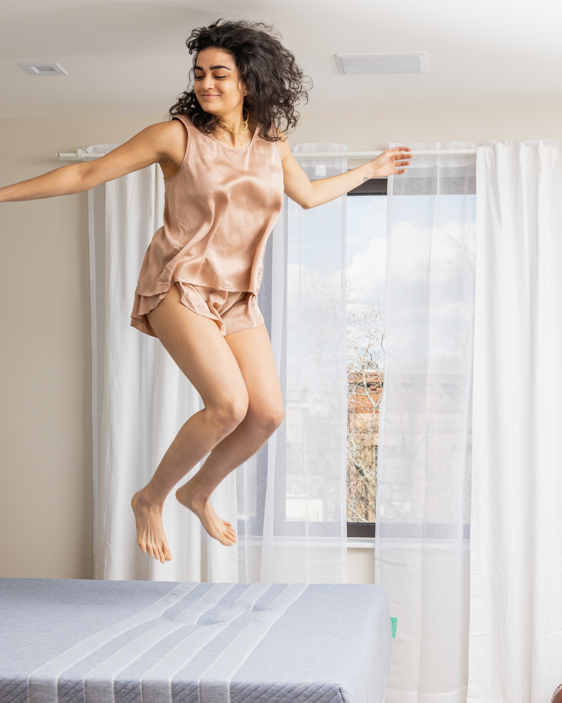 lady jumping on a mattress